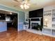 Inviting living room with a fireplace, built-in shelving, and hardwood floors, adjacent to a kitchen at 712 E Horne St, Clayton, NC 27520