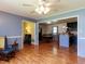 Open-concept living area showcasing hardwood floors with a dining area and kitchen beyond at 712 E Horne St, Clayton, NC 27520