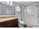 Updated bathroom featuring a modern vanity, stylish tile flooring, and a glass-enclosed shower at 716 Sandra St, Garner, NC 27529