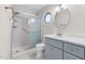 Bathroom featuring an octagonal window over the toilet, shower with glass doors, and a vanity with modern fixtures at 716 Sandra St, Garner, NC 27529
