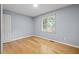 Bright and airy bedroom featuring hardwood floors, natural light, and freshly painted walls at 716 Sandra St, Garner, NC 27529
