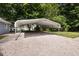 Gravel carport offers a spacious covered parking area near a home with mature trees at 716 Sandra St, Garner, NC 27529