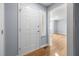 Welcoming entryway with a white front door and light-colored hardwood floors at 716 Sandra St, Garner, NC 27529