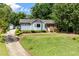 Inviting home with neat landscaping, a mix of blue siding and brick, and a paved driveway at 716 Sandra St, Garner, NC 27529