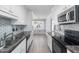 Updated kitchen with stainless steel appliances, light countertops, and tile backsplash at 716 Sandra St, Garner, NC 27529