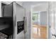 Modern stainless steel refrigerator in an updated kitchen with granite countertops and hardwood floors at 716 Sandra St, Garner, NC 27529