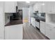 Well-lit kitchen with white cabinets, modern appliances, and subway tile backsplash at 716 Sandra St, Garner, NC 27529