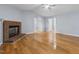 Cozy living room featuring a brick fireplace and hardwood floors at 716 Sandra St, Garner, NC 27529