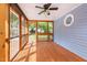 Relaxing screened-in porch with wooden floors, ceiling fan, and natural light at 716 Sandra St, Garner, NC 27529
