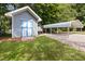 Outdoor shed and carport offering ample storage and parking space on a well-kept lawn at 716 Sandra St, Garner, NC 27529
