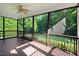 Enclosed back porch with a ceiling fan and views of the lush backyard at 74 Fountain Dr, Clayton, NC 27520