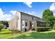 View of the home's backyard featuring a manicured lawn and exterior view of the house, including a screened porch at 74 Fountain Dr, Clayton, NC 27520