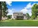 View of the home's backyard featuring a spacious lawn and exterior view of the house, including a screened porch at 74 Fountain Dr, Clayton, NC 27520