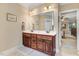 Bathroom featuring a double sink vanity with wood cabinets and a large mirror at 74 Fountain Dr, Clayton, NC 27520