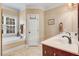 Bright bathroom with a soaking tub under a window and double sink vanity at 74 Fountain Dr, Clayton, NC 27520