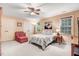 Inviting bedroom with a ceiling fan, plush armchair, and natural light at 74 Fountain Dr, Clayton, NC 27520