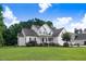Spacious home exterior with a large front yard, mature trees, and well-maintained landscaping at 74 Fountain Dr, Clayton, NC 27520