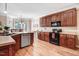 Bright kitchen with wood cabinetry, stainless steel appliances, and a breakfast area with a large window at 74 Fountain Dr, Clayton, NC 27520