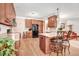Bright kitchen featuring hardwood floors and an eat-in island with seating at 74 Fountain Dr, Clayton, NC 27520