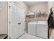 Practical laundry room with washer, dryer, and convenient shelving at 74 Fountain Dr, Clayton, NC 27520