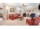 Open-concept living room with neutral carpet, fireplace, and staircase access at 74 Fountain Dr, Clayton, NC 27520