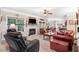 Inviting living room with fireplace, ceiling fan, and multiple seating areas at 74 Fountain Dr, Clayton, NC 27520