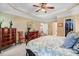 Comfortable bedroom featuring a ceiling fan, soft carpet, and ample natural light at 74 Fountain Dr, Clayton, NC 27520