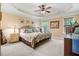Cozy main bedroom featuring a tray ceiling, neutral walls, and a large window at 74 Fountain Dr, Clayton, NC 27520