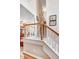 A carpeted staircase with white wooden banister and natural wood railing at 74 Fountain Dr, Clayton, NC 27520