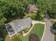 Aerial view of property showing mature trees and well-maintained landscaping at 7917 Rooksley Ct, Raleigh, NC 27615