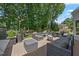 Spacious backyard deck with a grill, a sitting area, and lush green landscaping at 7917 Rooksley Ct, Raleigh, NC 27615