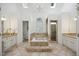 Bright bathroom with a jacuzzi tub, double vanity, tile floor, skylights and walk-in shower at 7917 Rooksley Ct, Raleigh, NC 27615