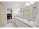 Large bathroom featuring a double vanity, an oversized mirror, and decorative fixtures at 7917 Rooksley Ct, Raleigh, NC 27615