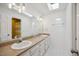 Bathroom featuring double sinks, granite countertops, and a tiled floor at 7917 Rooksley Ct, Raleigh, NC 27615