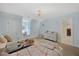Light blue bedroom with two twin beds, modern chandelier and ensuite bathroom at 7917 Rooksley Ct, Raleigh, NC 27615