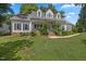 Charming single-Gathering home featuring a welcoming front porch and lush landscaping at 7917 Rooksley Ct, Raleigh, NC 27615