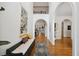 Elegant foyer with hardwood floors, arched doorways, and a decorative tapestry at 7917 Rooksley Ct, Raleigh, NC 27615