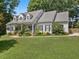 Inviting single-Gathering home featuring a covered front porch and beautifully landscaped yard at 7917 Rooksley Ct, Raleigh, NC 27615