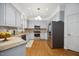 Modern kitchen features stainless steel appliances, granite counters and hardwood floors at 7917 Rooksley Ct, Raleigh, NC 27615