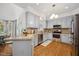 Updated kitchen featuring granite counters, stainless steel appliances and modern lighting at 7917 Rooksley Ct, Raleigh, NC 27615