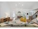 Bright living room with fireplace, hardwood floors, and comfortable seating arrangement at 7917 Rooksley Ct, Raleigh, NC 27615
