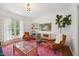 Comfortable living room with bright rug, view to outside, and entertainment center at 7917 Rooksley Ct, Raleigh, NC 27615