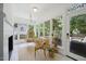 Bright sun room with a hanging chair, lots of windows, and access to the back patio at 7917 Rooksley Ct, Raleigh, NC 27615