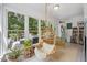 Sun room featuring hanging chair, lots of windows, patio access, lots of plants and a sitting area at 7917 Rooksley Ct, Raleigh, NC 27615