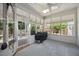 Bright sunroom with a grill, a skylight, and a view of the backyard at 7917 Rooksley Ct, Raleigh, NC 27615
