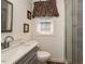 Bathroom with tile shower featuring a vanity with a sleek countertop and modern fixtures at 810 Grovemont Rd, Raleigh, NC 27603