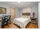 Inviting bedroom featuring hardwood floors, a cozy bed, and a classic wooden headboard at 810 Grovemont Rd, Raleigh, NC 27603