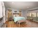 Bright and airy bedroom featuring hardwood floors, ample natural light, and decorative curtains at 810 Grovemont Rd, Raleigh, NC 27603