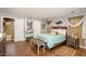 Inviting bedroom with wood floors, neutral decor, and a comfortable-looking queen-sized bed at 810 Grovemont Rd, Raleigh, NC 27603