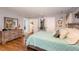 Tranquil bedroom featuring hardwood floors, a dresser, and soft lighting for a relaxing ambiance at 810 Grovemont Rd, Raleigh, NC 27603